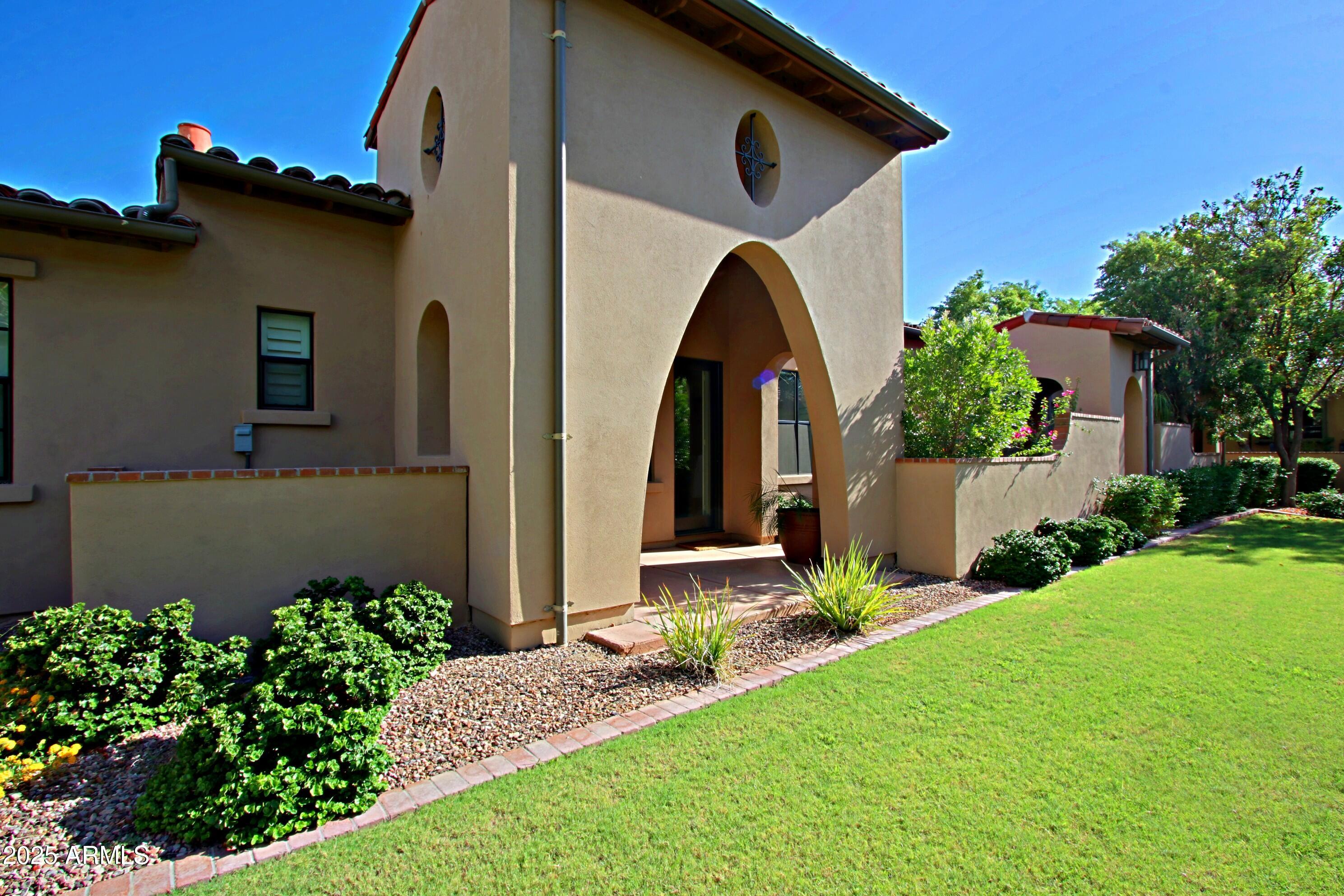 18650 North Thompson Peak Parkway, Unit 1052 Scottsdale, AZ 85255 - Photo 26 of 38 a front view of a house with garden