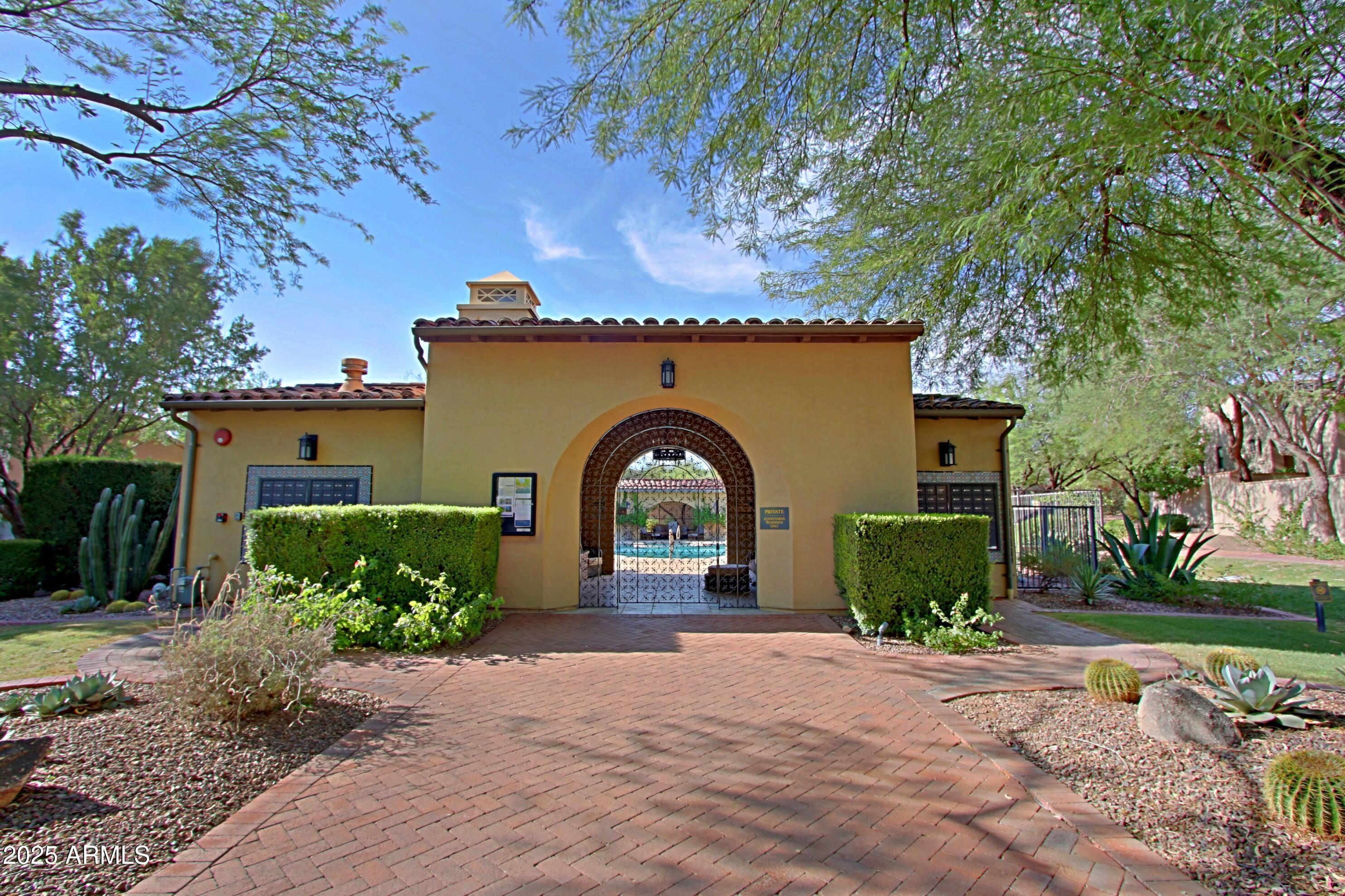 18650 North Thompson Peak Parkway, Unit 1052 Scottsdale, AZ 85255 - Photo 27 of 38 a front view of a house with a yard and a garage