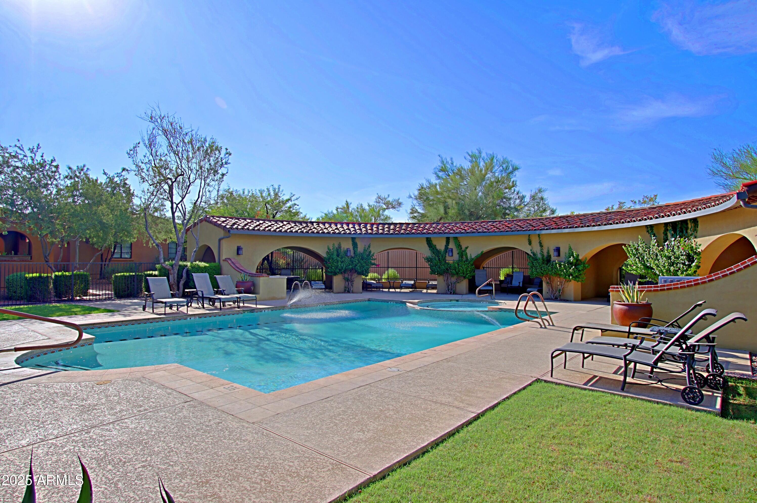 18650 North Thompson Peak Parkway, Unit 1052 Scottsdale, AZ 85255 - Photo 29 of 38 a view of a patio with a table and chairs under an umbrella