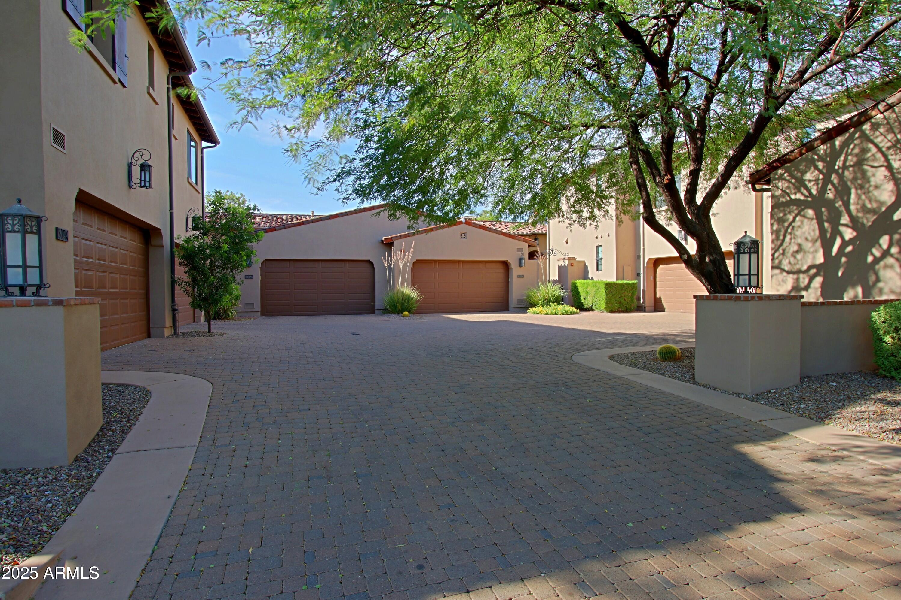 18650 North Thompson Peak Parkway, Unit 1052 Scottsdale, AZ 85255 - Photo 30 of 38 a front view of a house with a yard and garage
