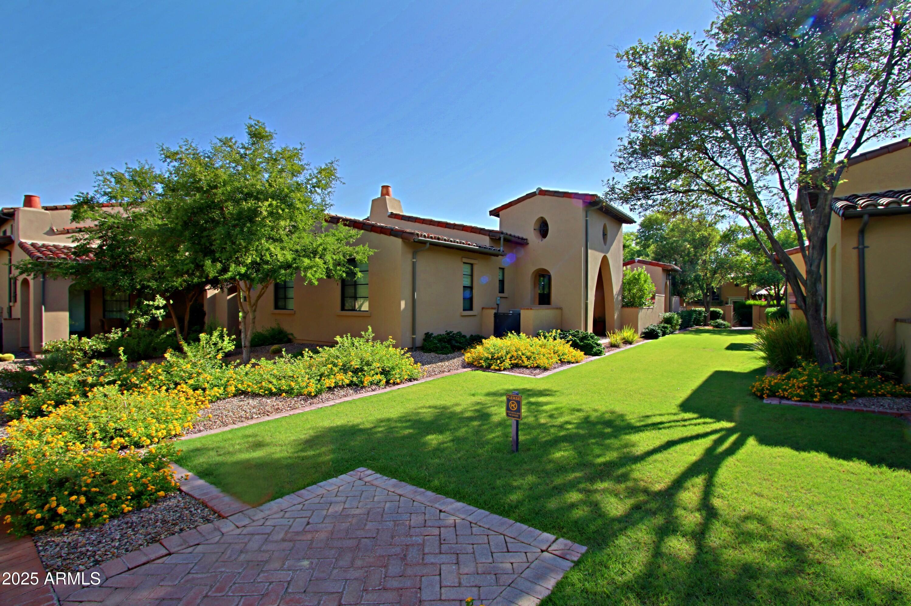18650 North Thompson Peak Parkway, Unit 1052 Scottsdale, AZ 85255 - Photo 32 of 38 a front view of a house with garden