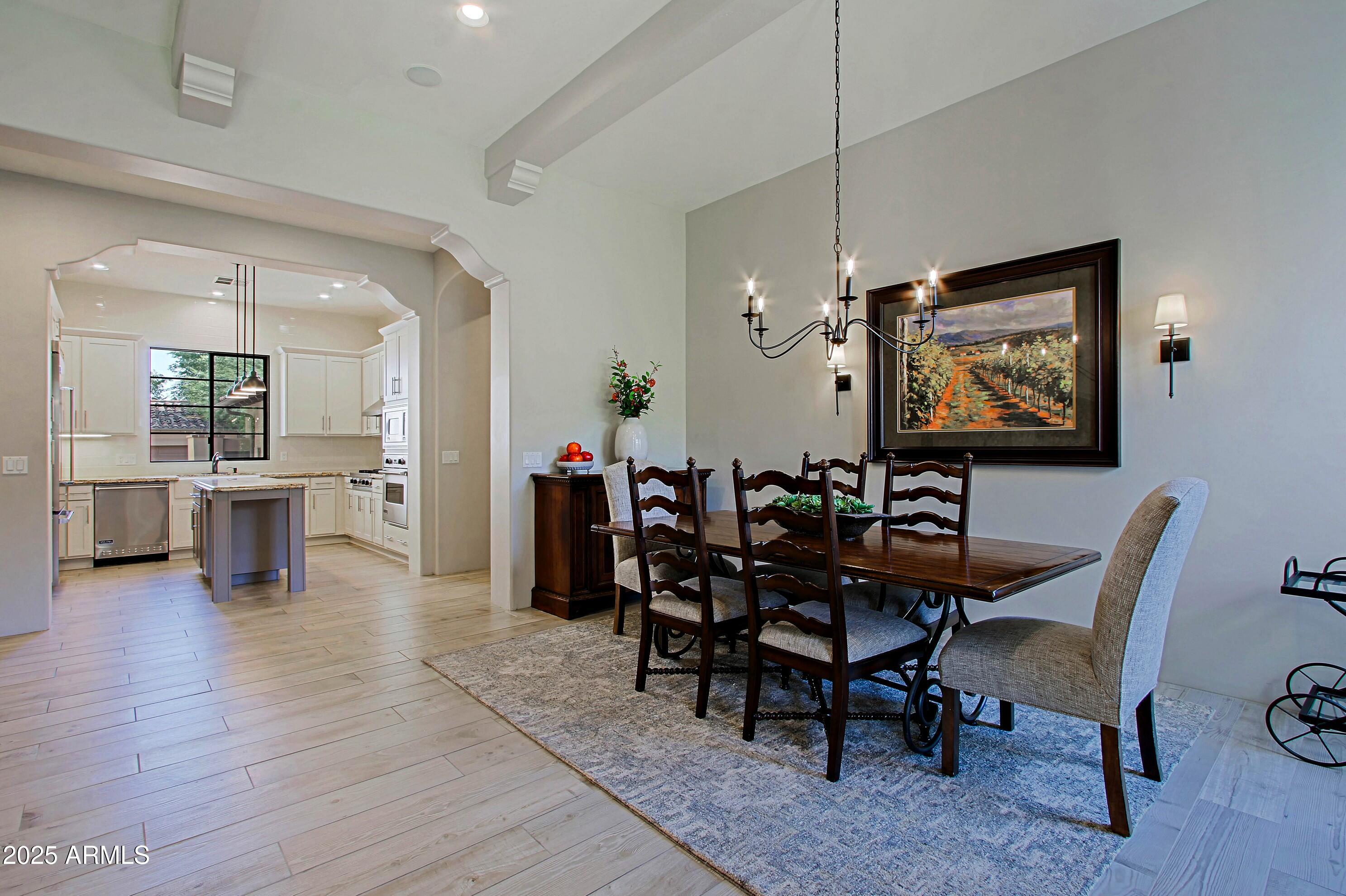 18650 North Thompson Peak Parkway, Unit 1052 Scottsdale, AZ 85255 - Photo 10 of 38 a view of a dining room with furniture and wooden floor