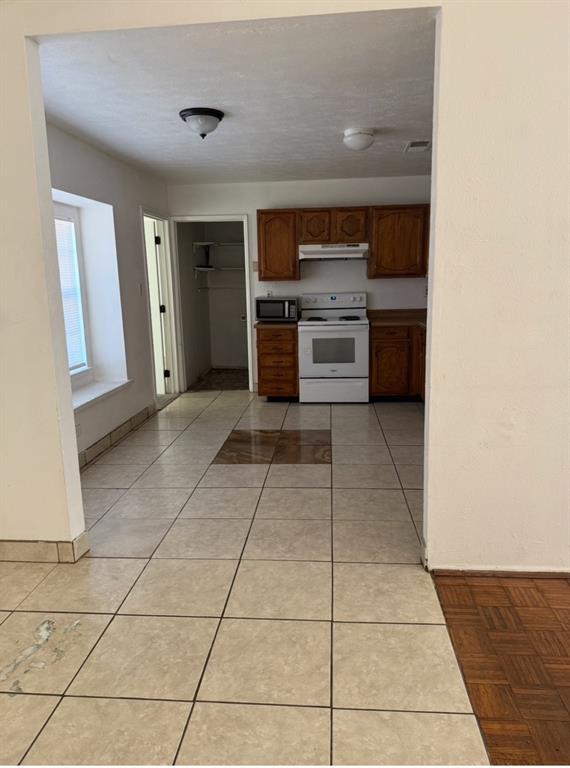 7417 Sorcey Road Dallas, TX 75249 - Photo 4 of 6 a view of kitchen with stainless steel appliances granite countertop a stove top oven cabinets a sink and a counter top