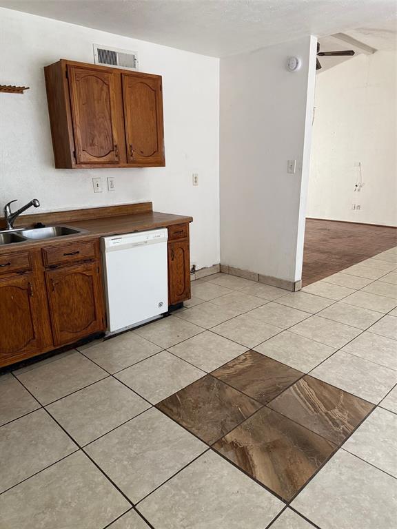 7417 Sorcey Road Dallas, TX 75249 - Photo 5 of 6 a kitchen with granite countertop a sink and a stove top oven