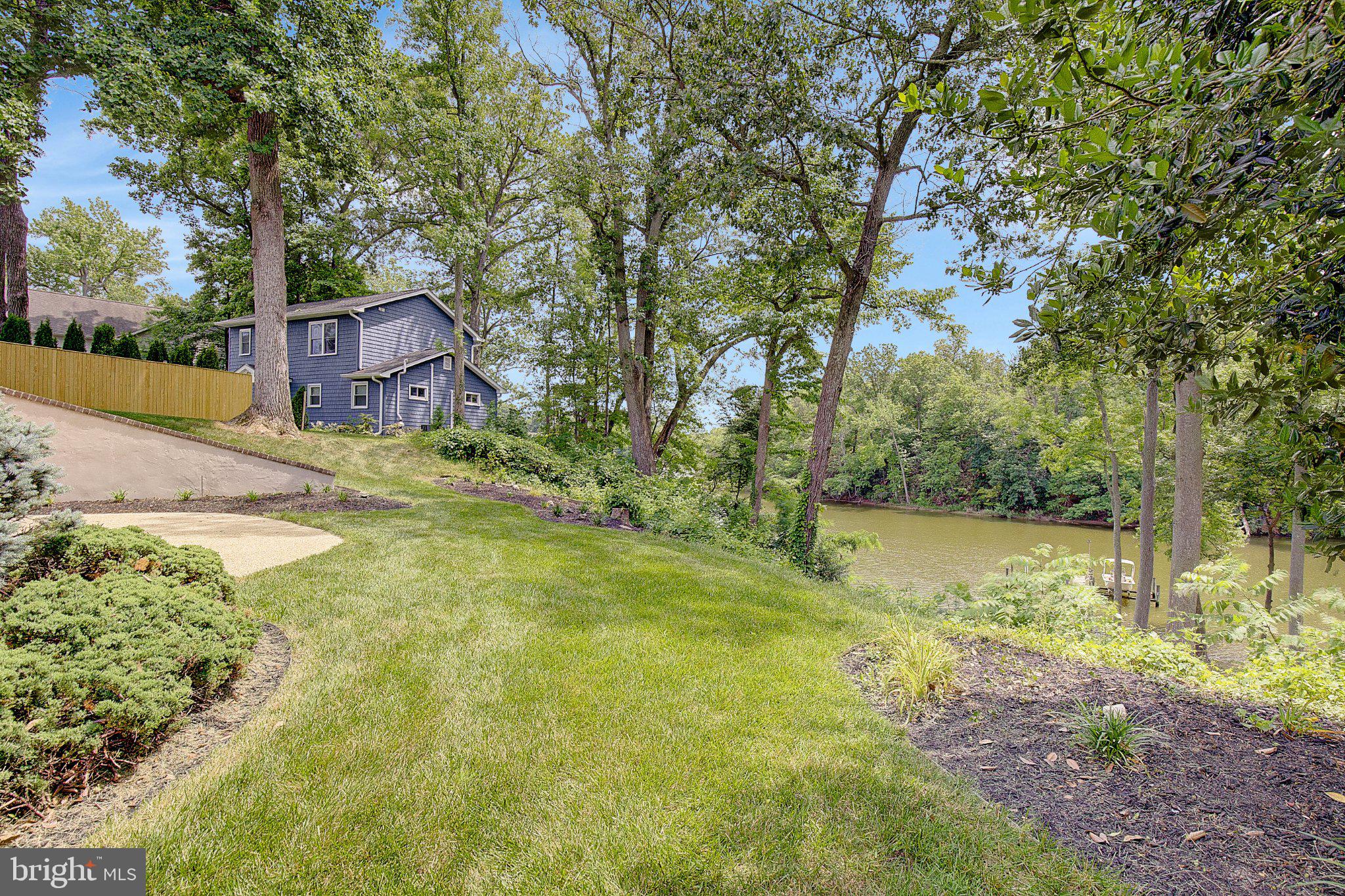 3088 Tudor Hall Road Riva, MD 21140 - Photo 13 of 62 Serene lakeside retreat with lush greenery.