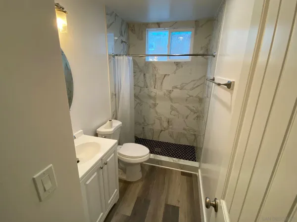 a bathroom with a toilet and a shower