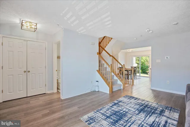 a view of entryway and hall with wooden floor