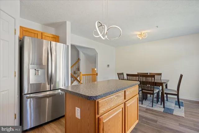 a kitchen with stainless steel appliances granite countertop a sink a stove and cabinets
