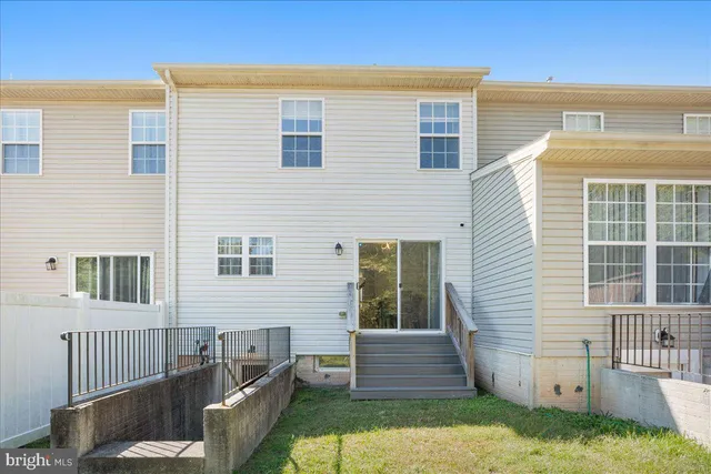 an aerial view of a swimming pool with outdoor seating