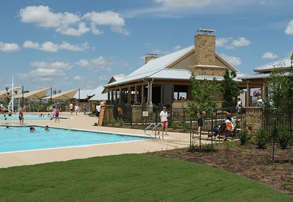 a front view of a building with a garden