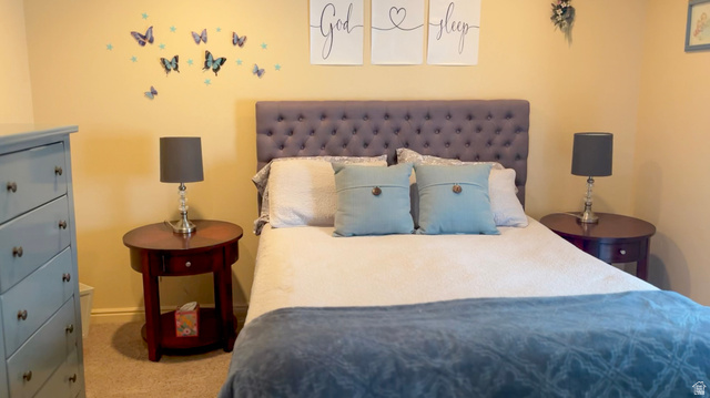 1797 Sunset Road Enoch, UT 84721 - Photo 39 of 80 Bedroom featuring a tufted upholstered headboard and light-toned walls