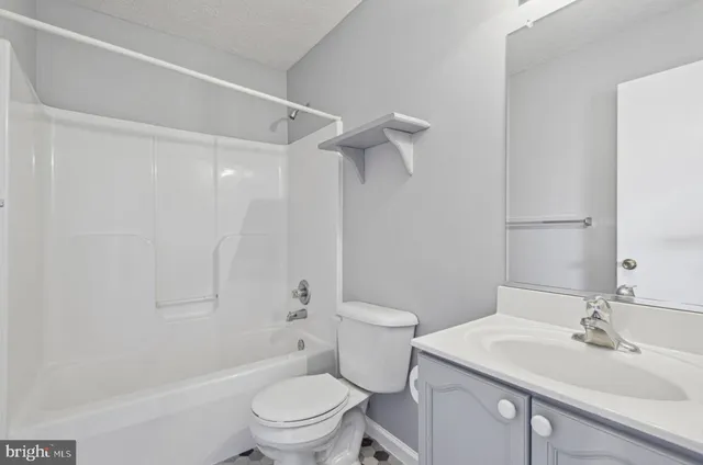 a bathroom with a sink toilet vanity and shower