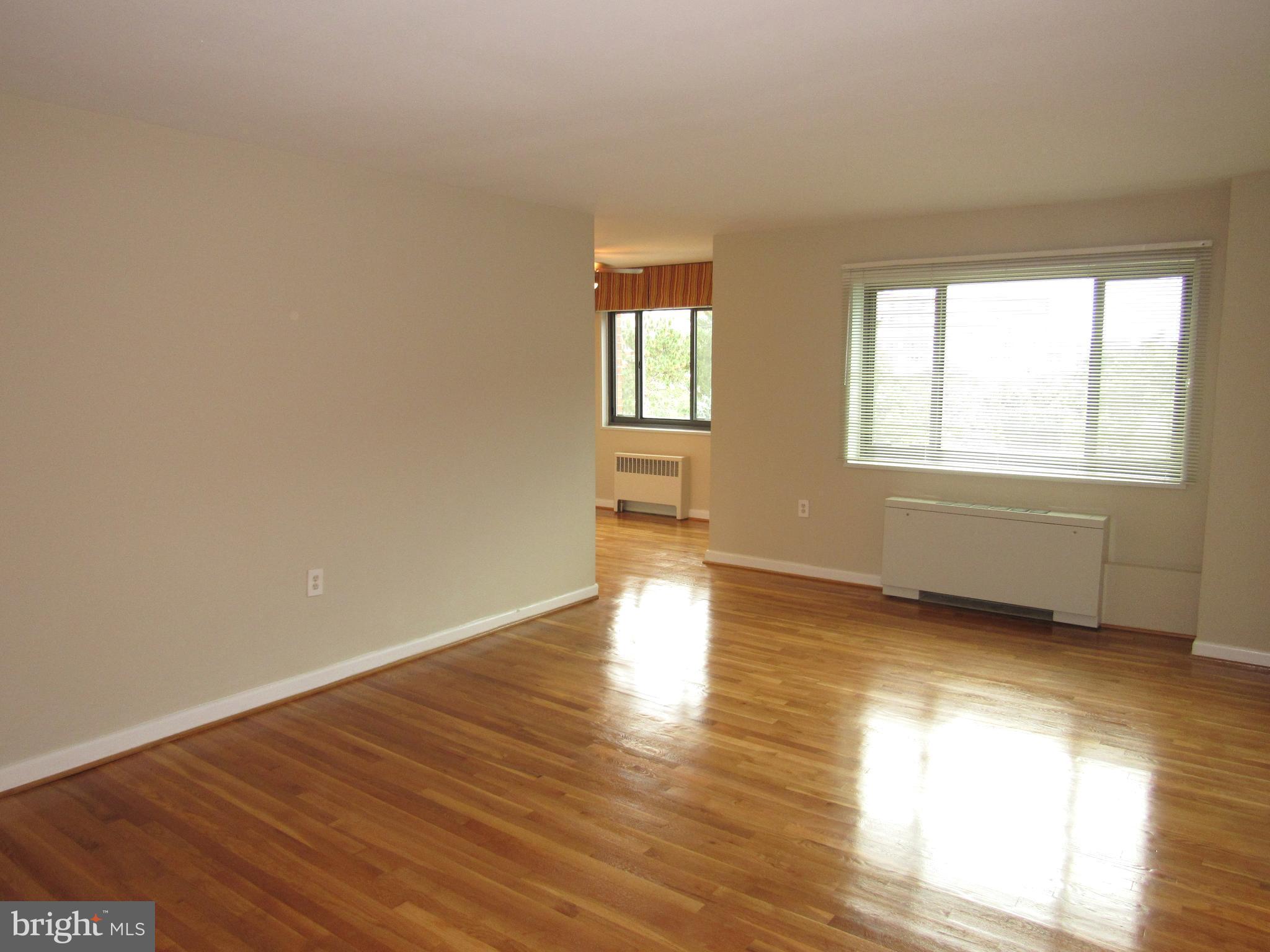 1300 South Arlington Ridge Road, Unit 617 Arlington, VA 22202 - Photo 2 of 25 an empty room with wooden floor and windows