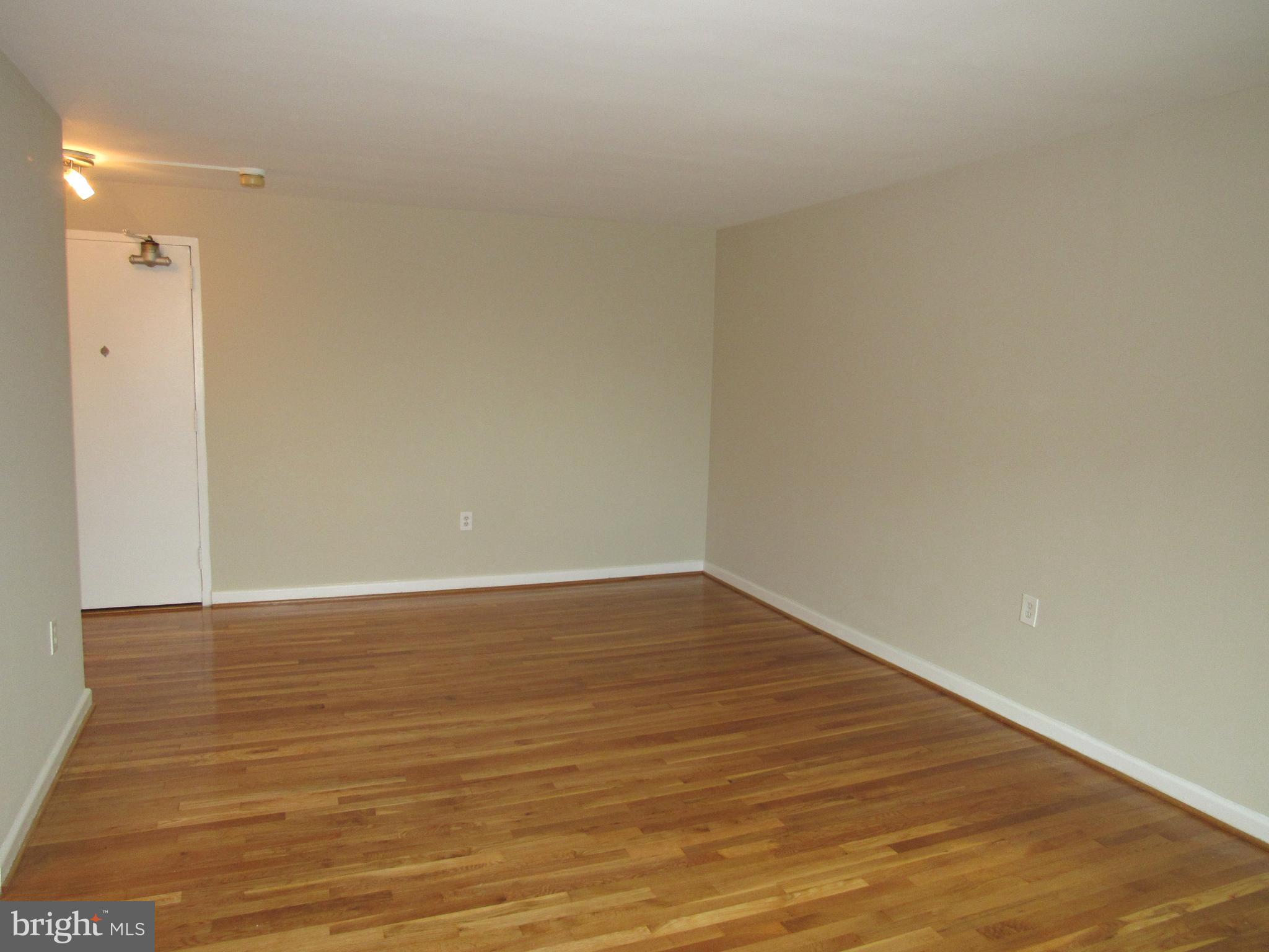 1300 South Arlington Ridge Road, Unit 617 Arlington, VA 22202 - Photo 11 of 25 a view of an empty room with wooden floor