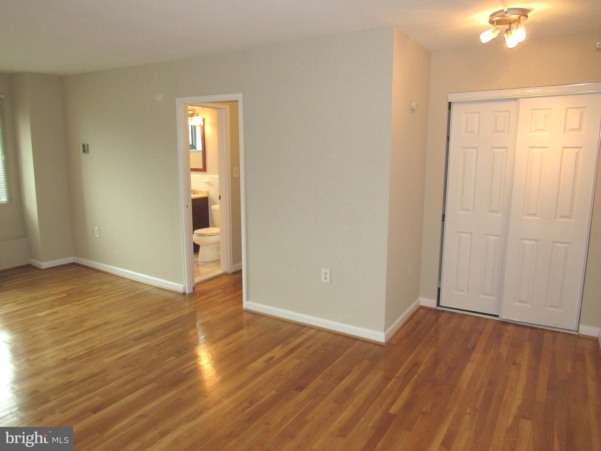 1300 South Arlington Ridge Road, Unit 617 Arlington, VA 22202 - Photo 3 of 25 an empty room with wooden floor and closet