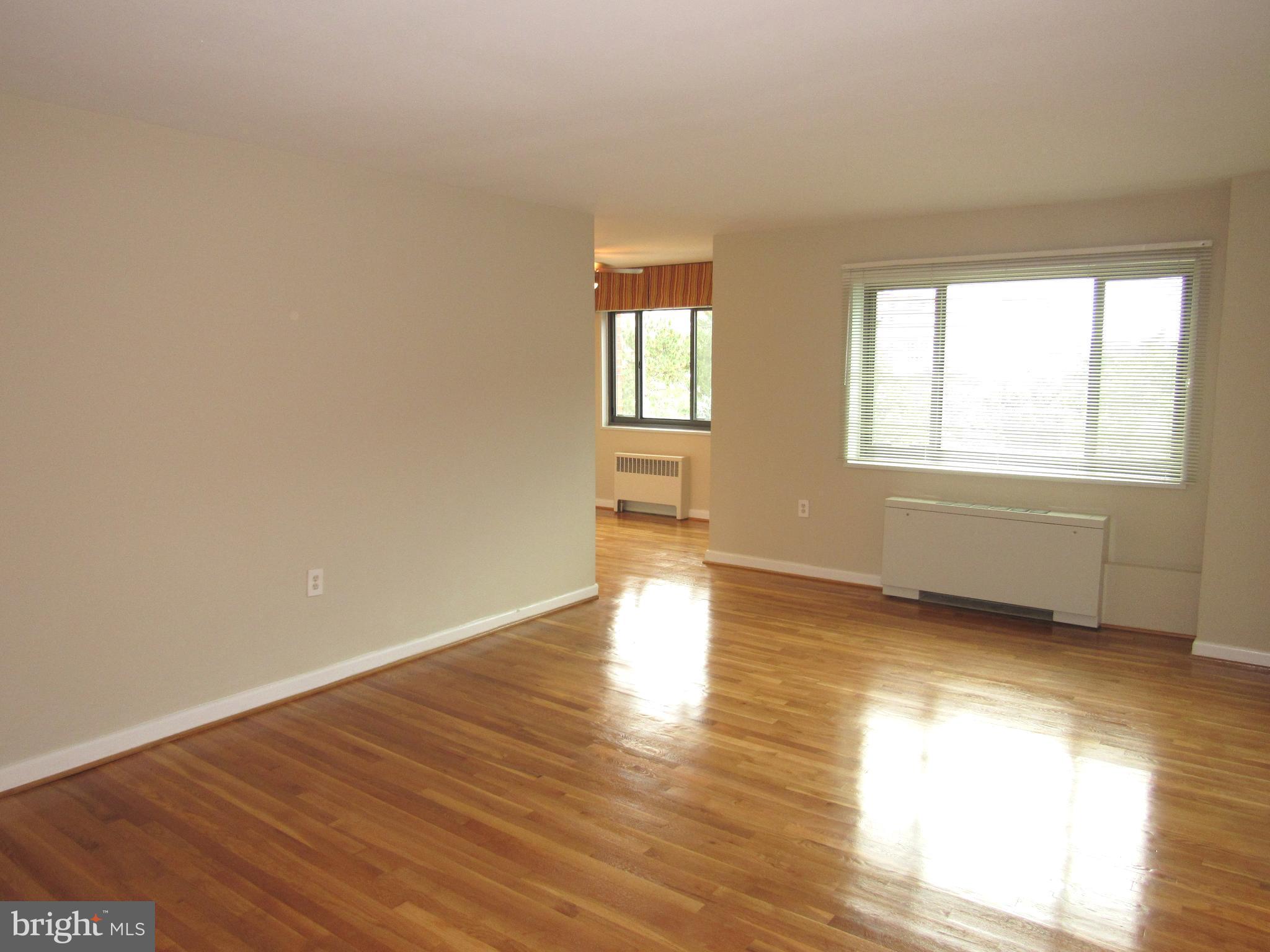 1300 South Arlington Ridge Road, Unit 617 Arlington, VA 22202 - Photo 5 of 25 an empty room with wooden floor and windows