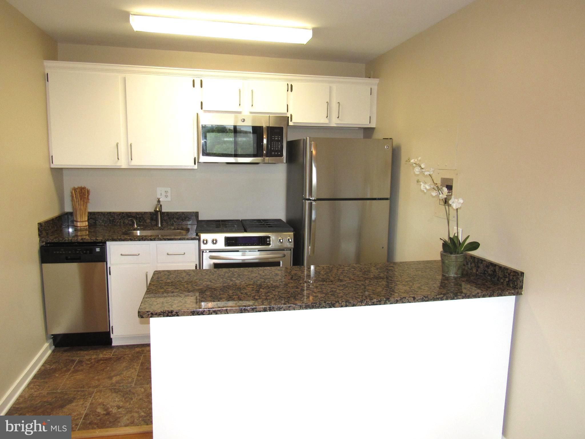 1300 South Arlington Ridge Road, Unit 617 Arlington, VA 22202 - Photo 7 of 25 a kitchen with a refrigerator sink and stove