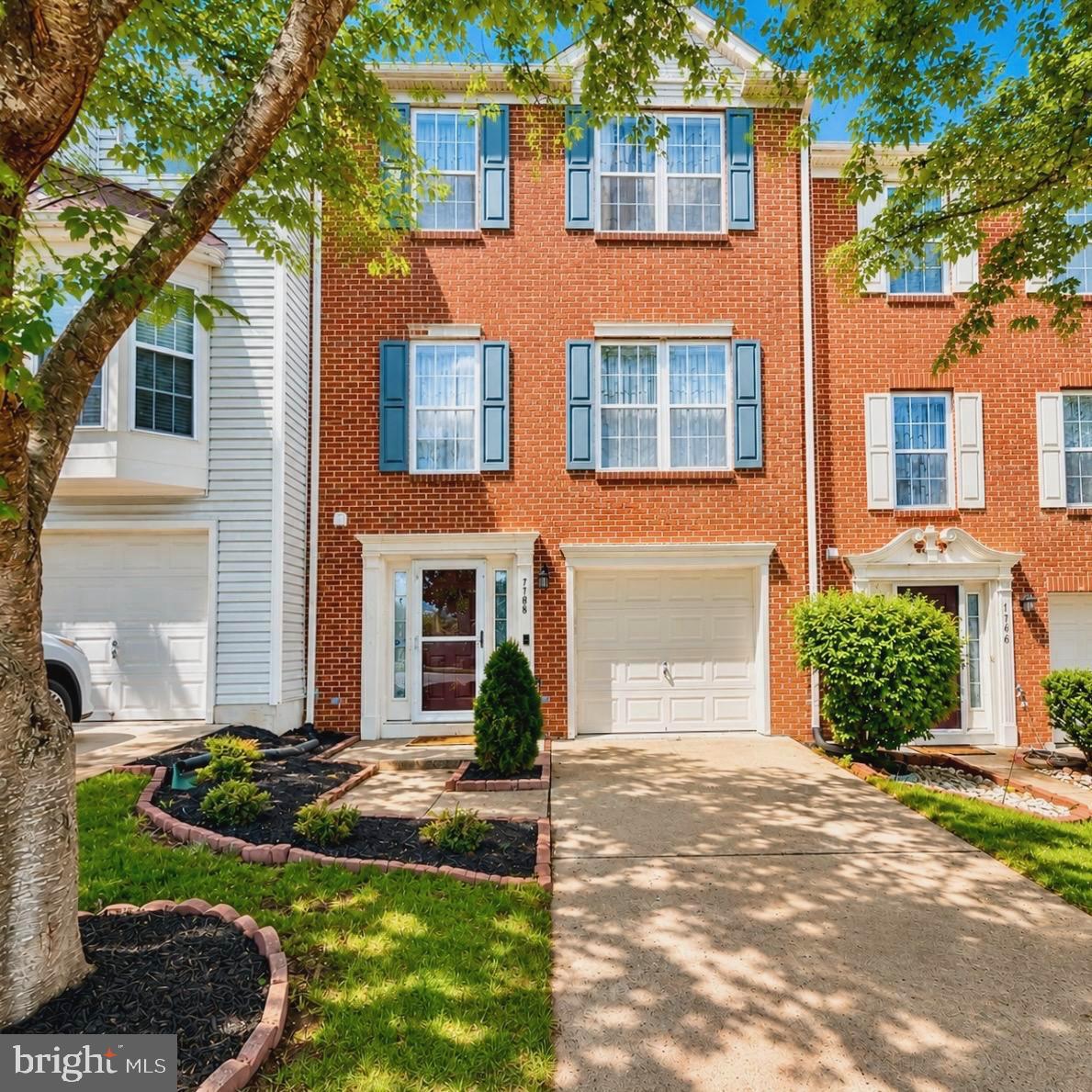 7108 Wheeling Way Gainesville, VA 20155 - Photo 1 of 45 a front view of a house with garden