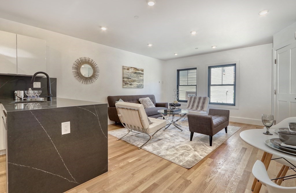4 Everett Place, Unit 1 Boston, MA 02128 - Photo 7 of 19 a living room with furniture two window and wooden floor
