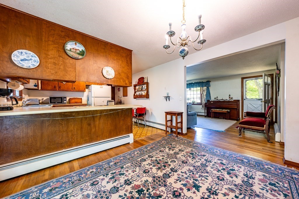 231 Monomoy Circle Barnstable, MA 02632 - Photo 11 of 28 a living room with furniture and a wooden floor