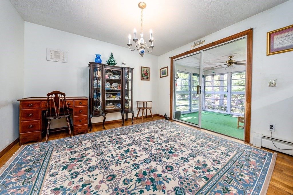 231 Monomoy Circle Barnstable, MA 02632 - Photo 12 of 28 a living room with furniture a rug and a window