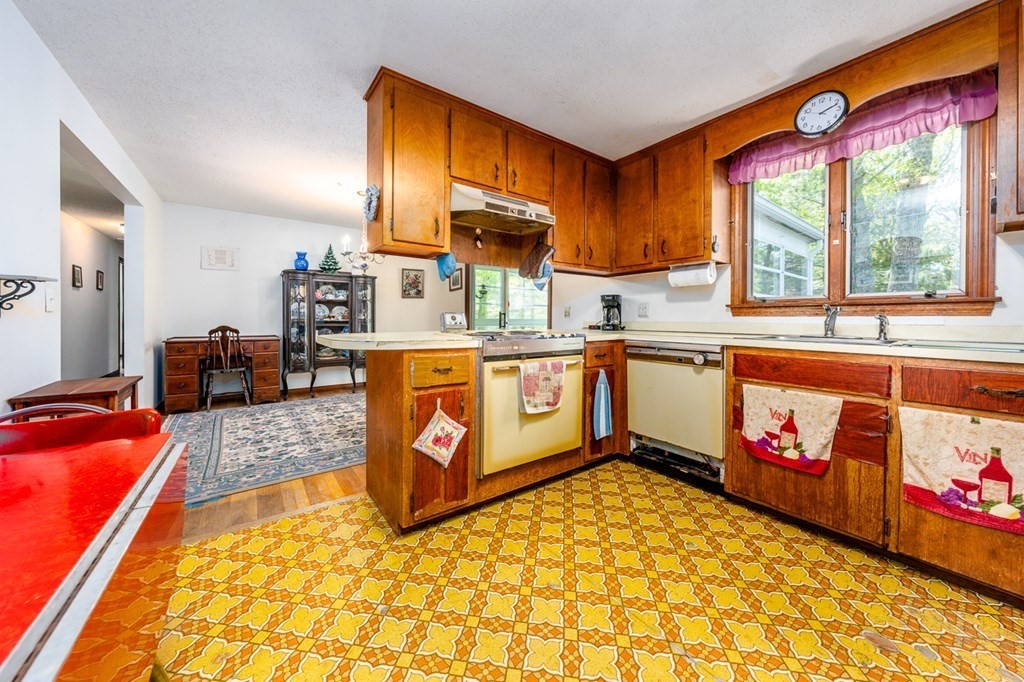 231 Monomoy Circle Barnstable, MA 02632 - Photo 14 of 28 a kitchen with stainless steel appliances granite countertop a stove a sink and a refrigerator