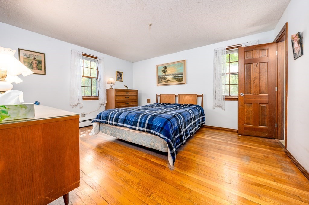 231 Monomoy Circle Barnstable, MA 02632 - Photo 19 of 28 a bedroom with a bed and window