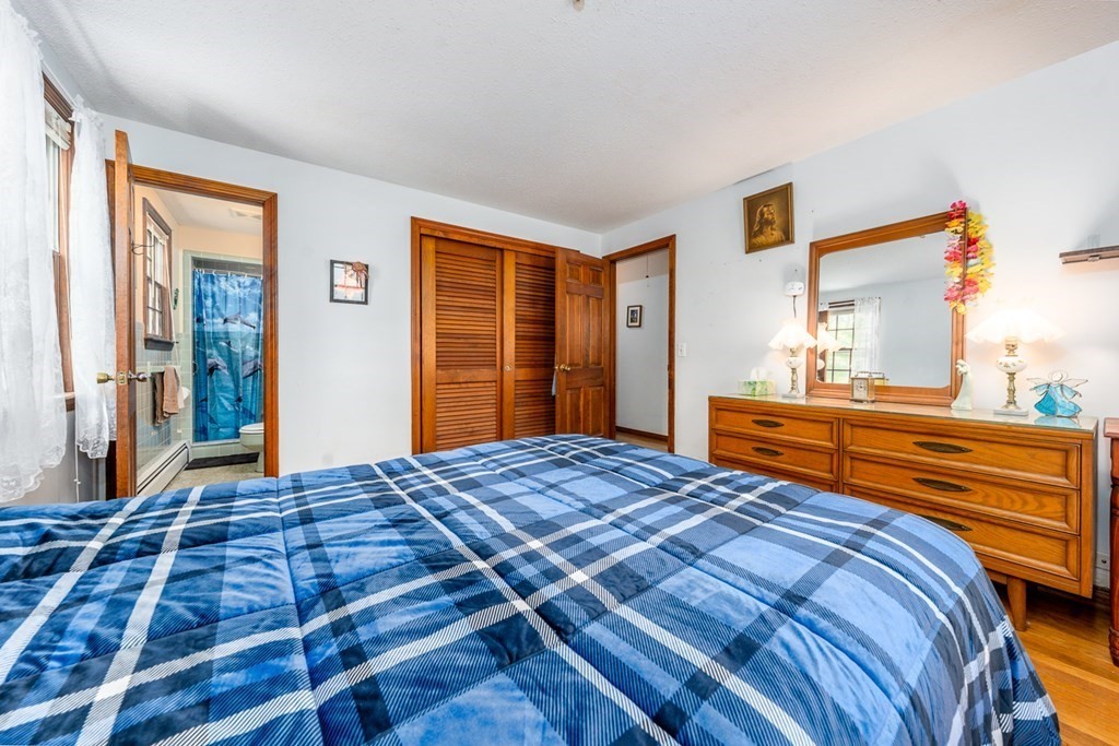 231 Monomoy Circle Barnstable, MA 02632 - Photo 20 of 28 a bedroom with a bed and a dresser