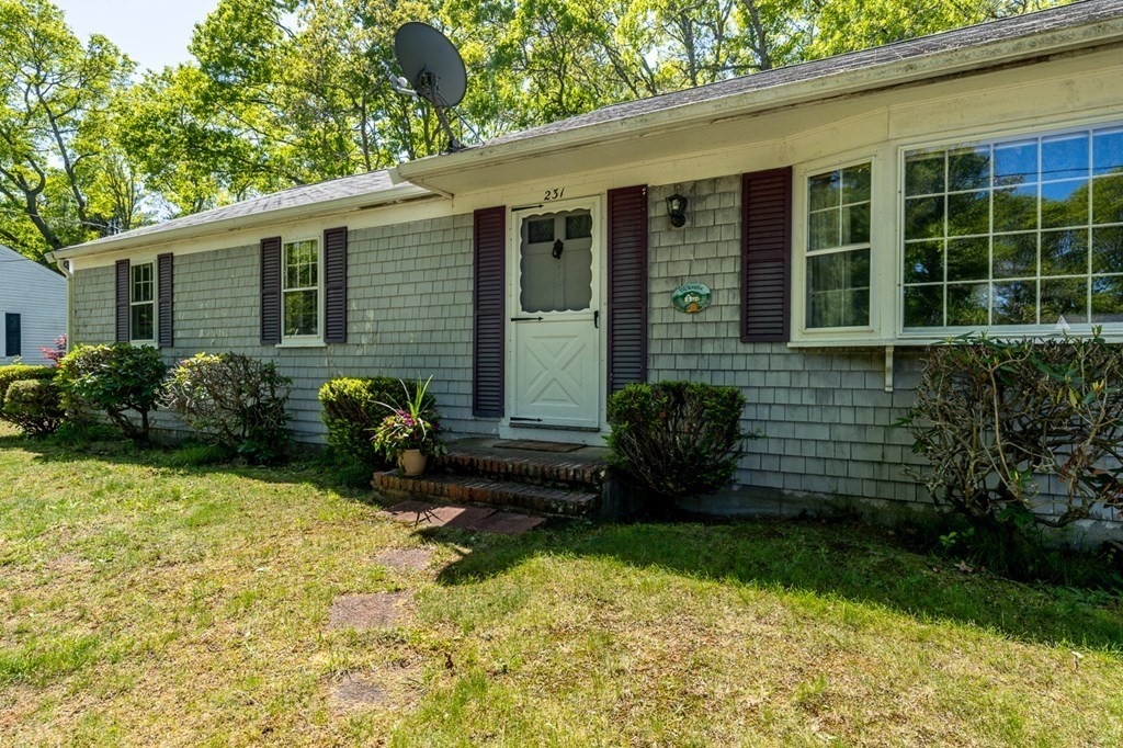 231 Monomoy Circle Barnstable, MA 02632 - Photo 2 of 28 a view of a house with backyard and garden