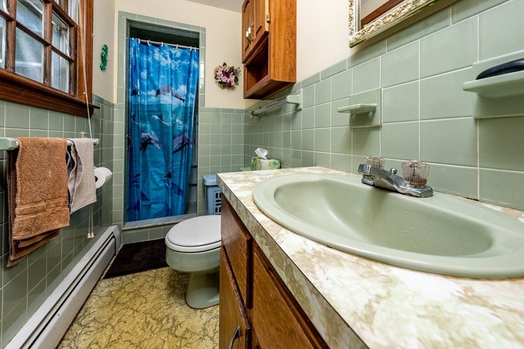 231 Monomoy Circle Barnstable, MA 02632 - Photo 21 of 28 a bathroom with a sink a toilet and shower