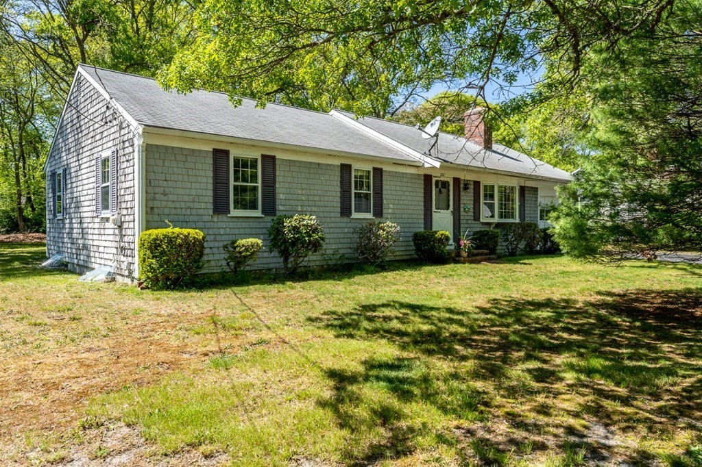 231 Monomoy Circle Barnstable, MA 02632 - Photo 3 of 28 a front view of a house with garden