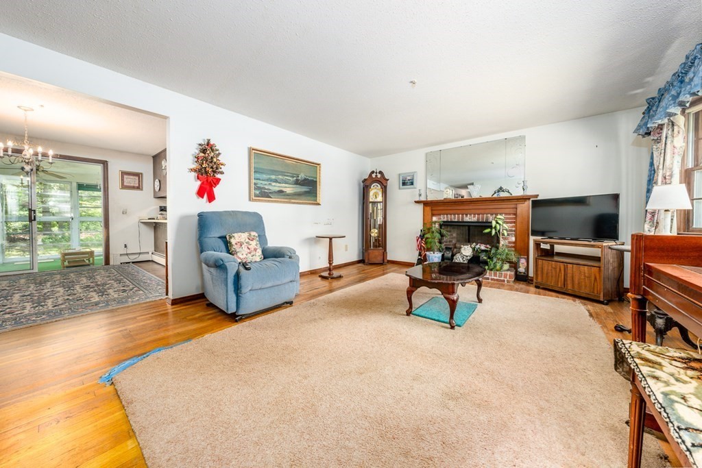 231 Monomoy Circle Barnstable, MA 02632 - Photo 7 of 28 a living room with furniture and a flat screen tv