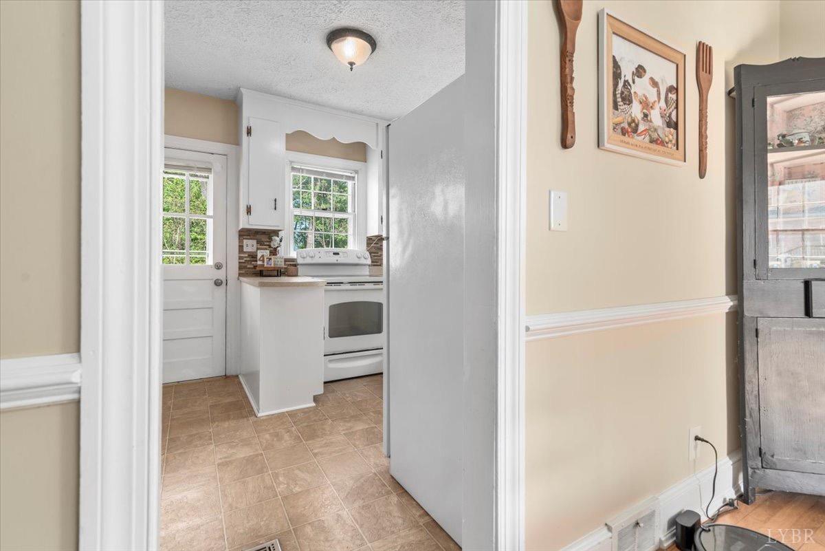 152 Pine Street Amherst, VA 24521 - Photo 11 of 53 a view of a hallway with workspace and windows