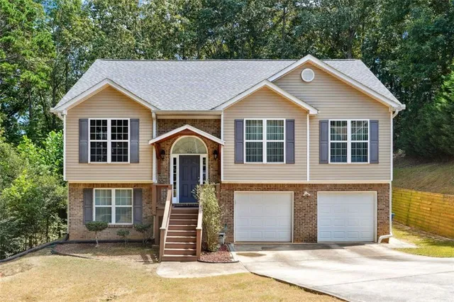 a front view of a house with a yard and garage