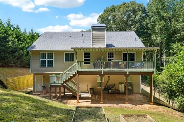 a view of house with swimming pool and sitting area