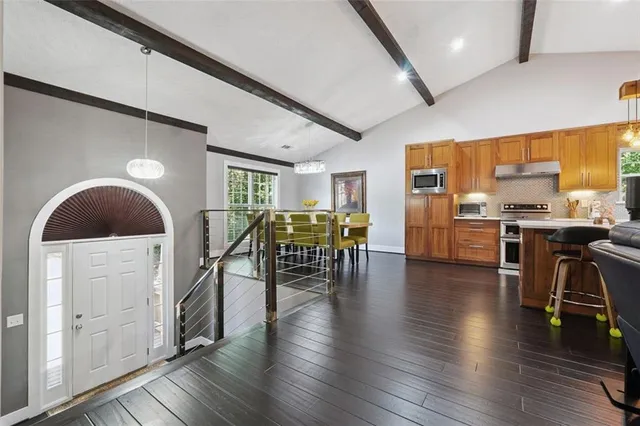 a dining room with furniture and wooden floor
