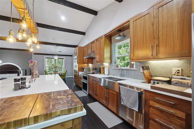 a kitchen with sink a stove and cabinets