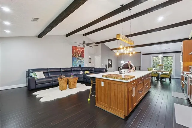 a kitchen with a stove and wooden floor