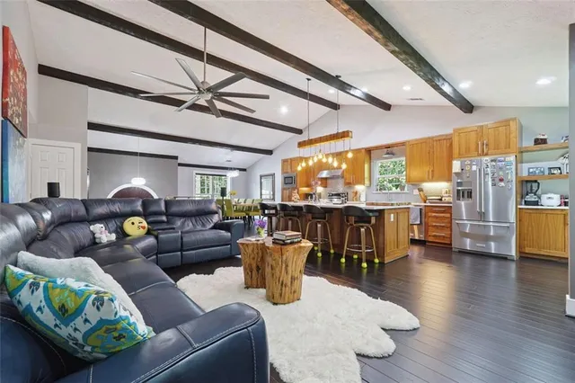 a living room with lots of furniture and kitchen view