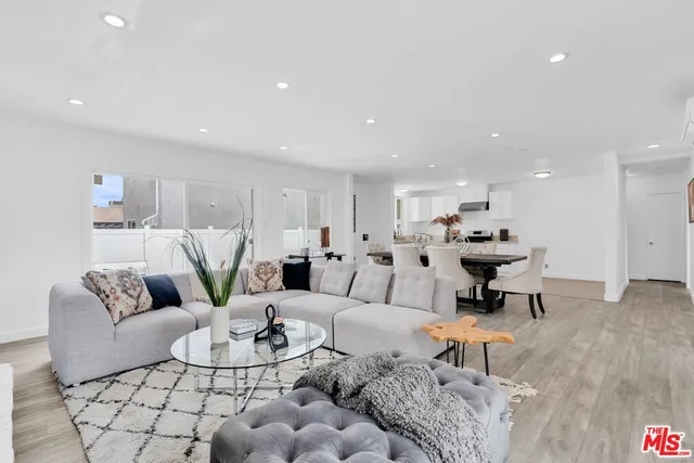 a dining room with furniture and wooden floor
