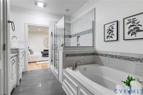 a bathroom with a tub a sink and glass door shower