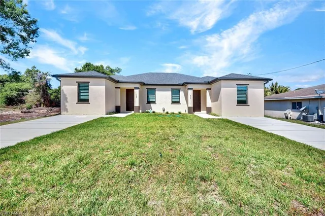 a front view of house with yard and green space