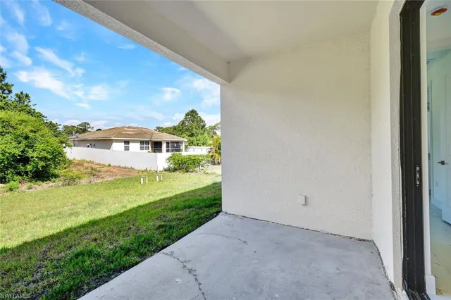 a view of an empty room with a closet and a window