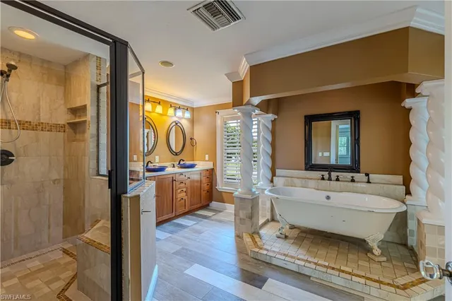 a bathroom with a granite countertop sink and a large mirror next to a window