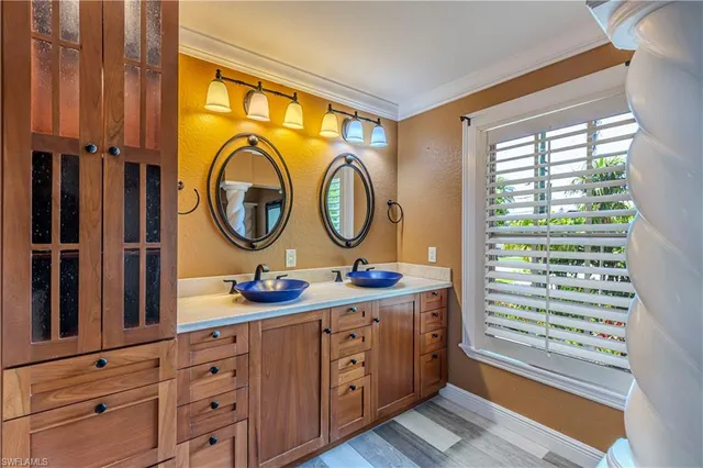 a bathroom with a tub a sink and a large mirror