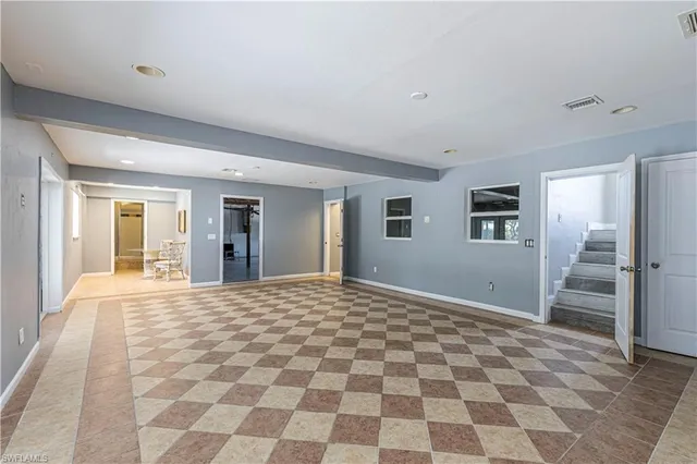 a view of a hallway with wooden floor and a window