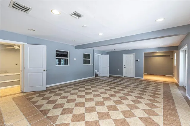 a bathroom with a granite countertop sink a toilet a mirror and shower