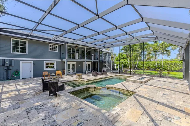 a swimming pool with outdoor seating and yard