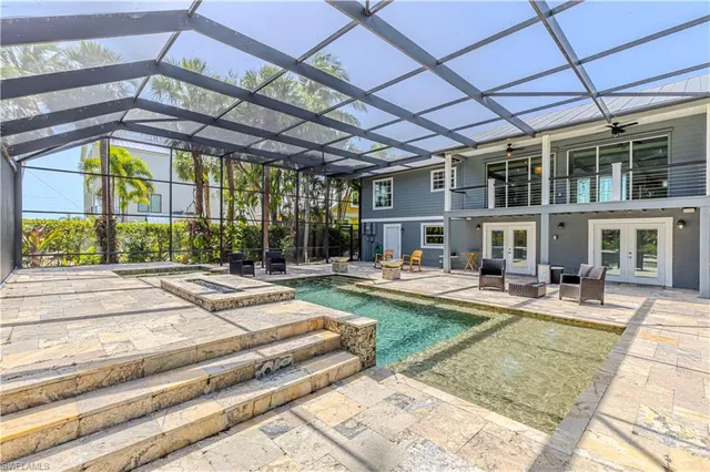 a front view of a house with garden and sitting area