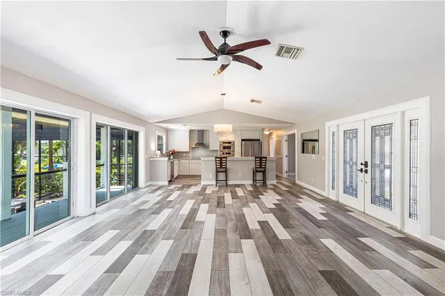 a view of a room with wooden floor and windows